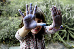 photograph of young girl with chalk on her hands