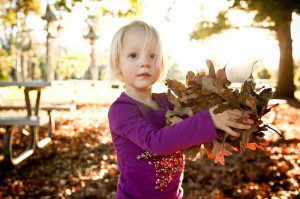Pasadena girl holding leaves in the park