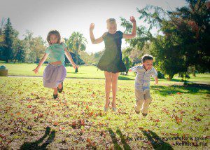 Three Pasadena children jumping in the air at Lacy Park