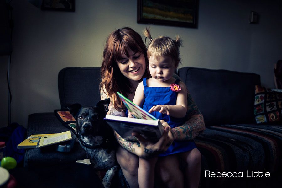 Daughter on mom's lap reading books Rebecca Little Photography