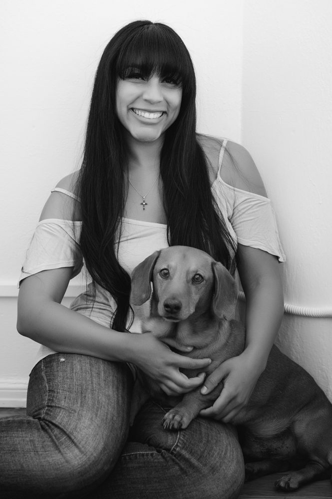 A black and white image of a Pasadena business owner with one of her dogs. She is a pet sitter and owns a business that lets seniors stay with their pets at home. Image by Rebecca Little Photography.